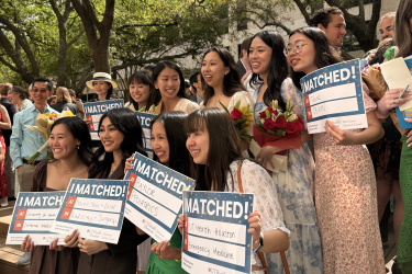 Group photo of students holding Match Day signs