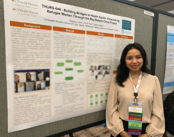 Meghna Lama in front of research poster.
