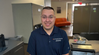 An image of Spencer Chichester in a work cubicle.