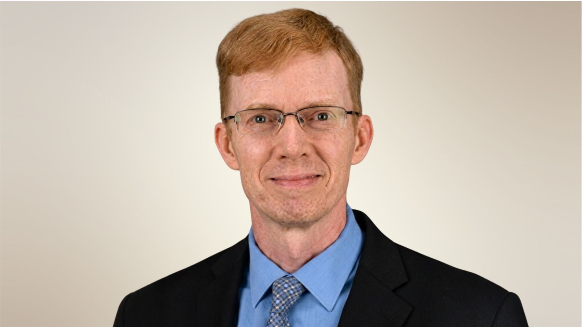 Casey Crump, MD, PhD, MPH,  professor in the Department of Family and Community Medicine at McGovern Medical School smiling in black suit and blue shirt. (Photo by UTHealth Houston)
