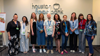 Center for Health Equity group standing in front of Houston Food Bank signage.