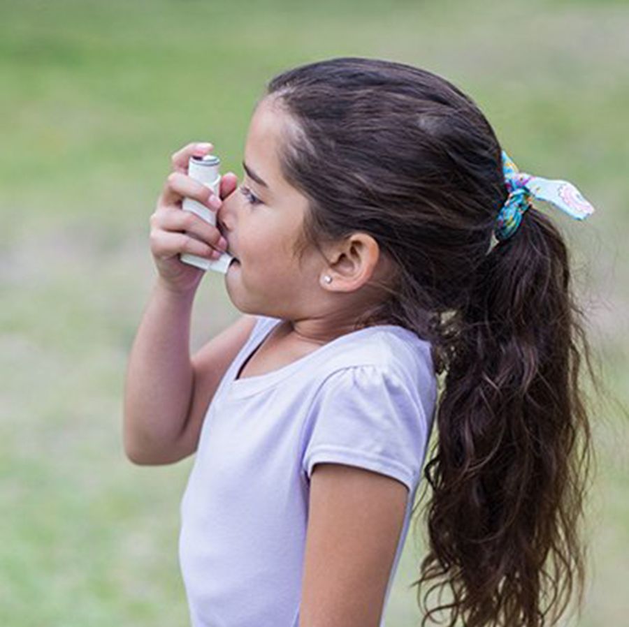 A young girl uses an inhaler. (Photo by Getty Images)