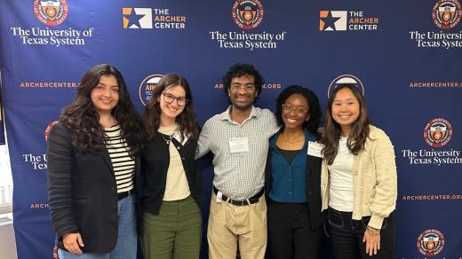 Archer fellows pictured in front of backdrop.