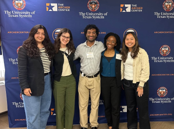 Archer fellows pictured in front of backdrop.
