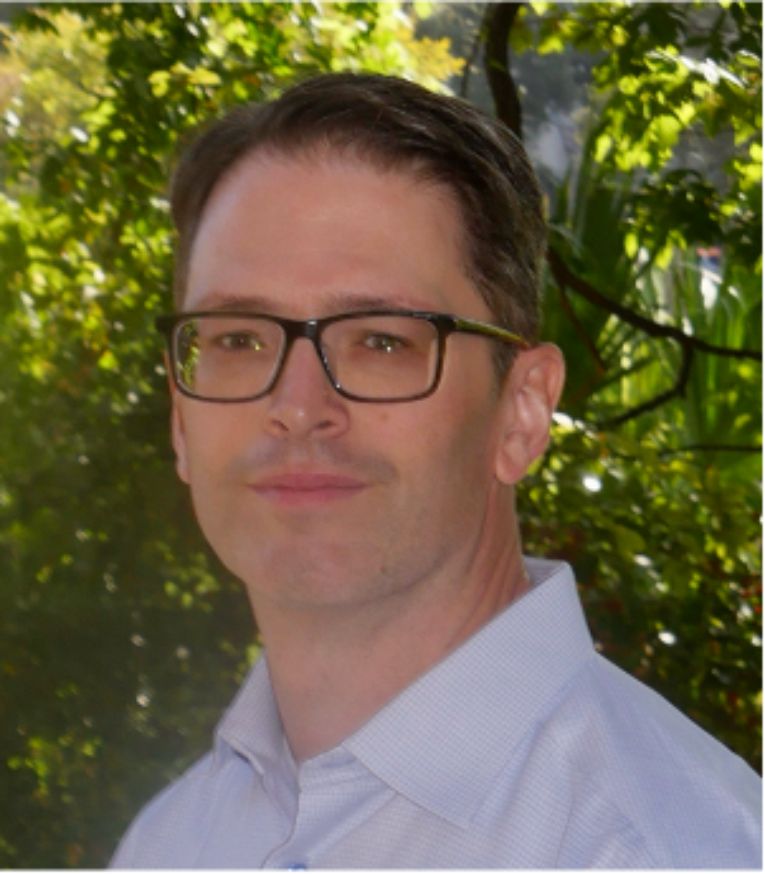 Benzer in front of bushes