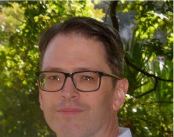 Benzer in front of bushes