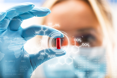 Female Scientist Holding Red Pill